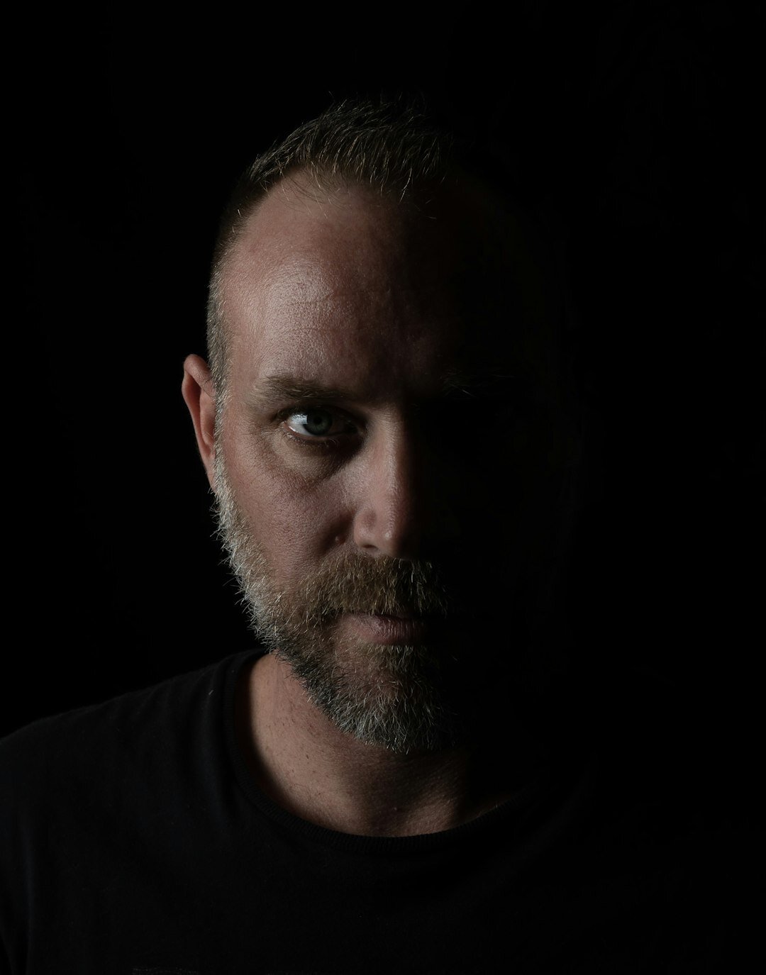 Studio portrait of a middle aged man with a beard
