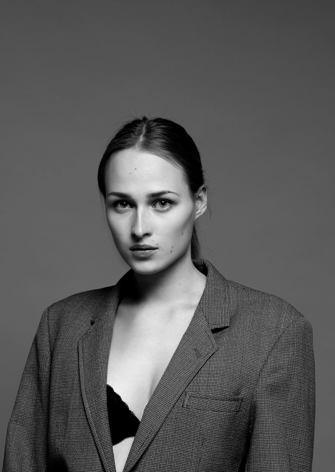 Studio portrait of a smiling businesswoman in a blazer